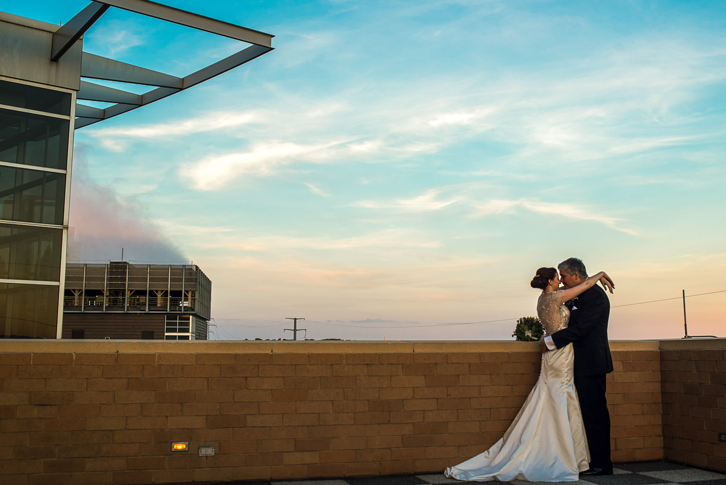 bride and groom on the balcony at the Science Museum of Minnesota