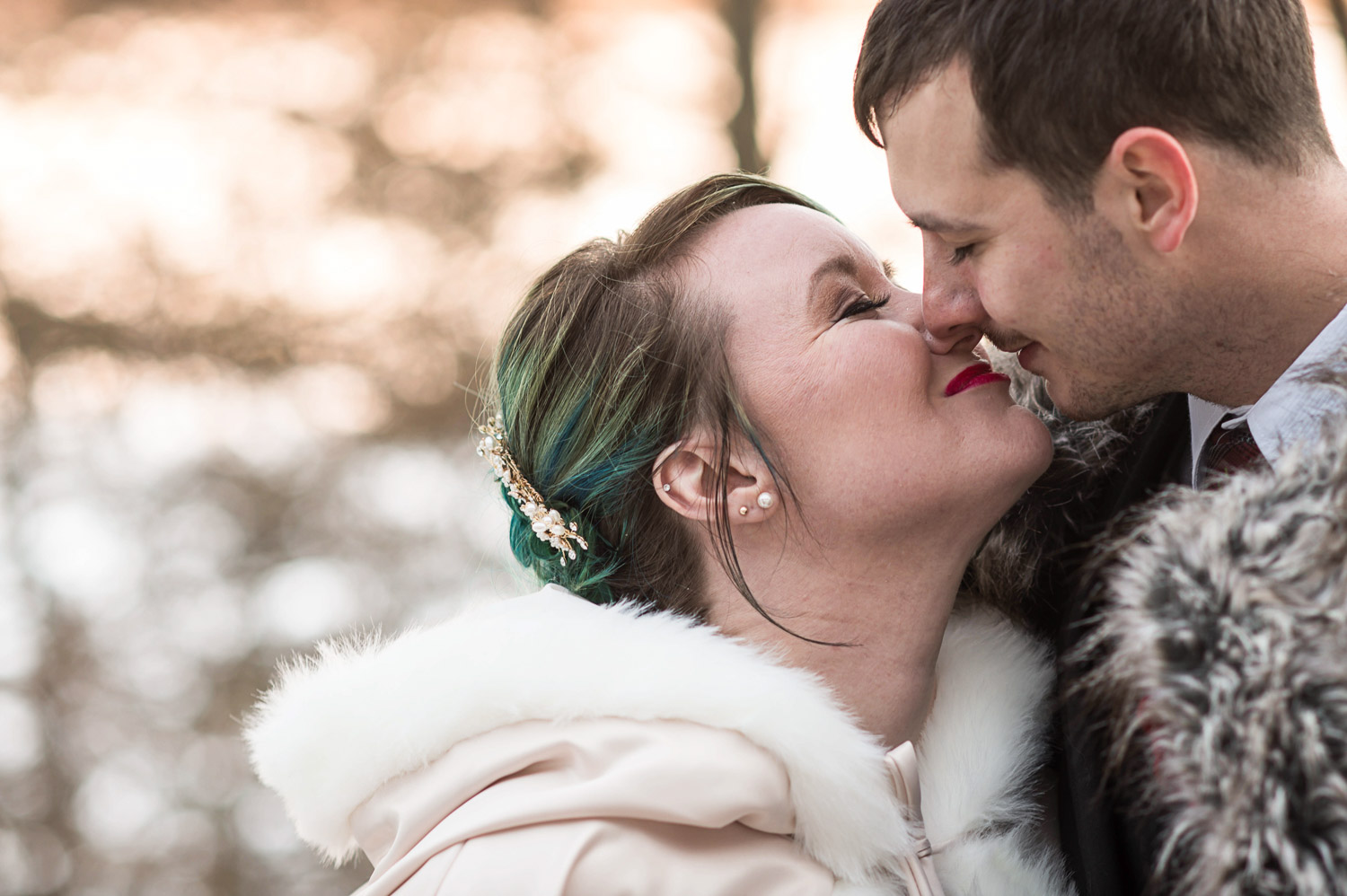first kiss during their outdoor winter wedding in Minnesota