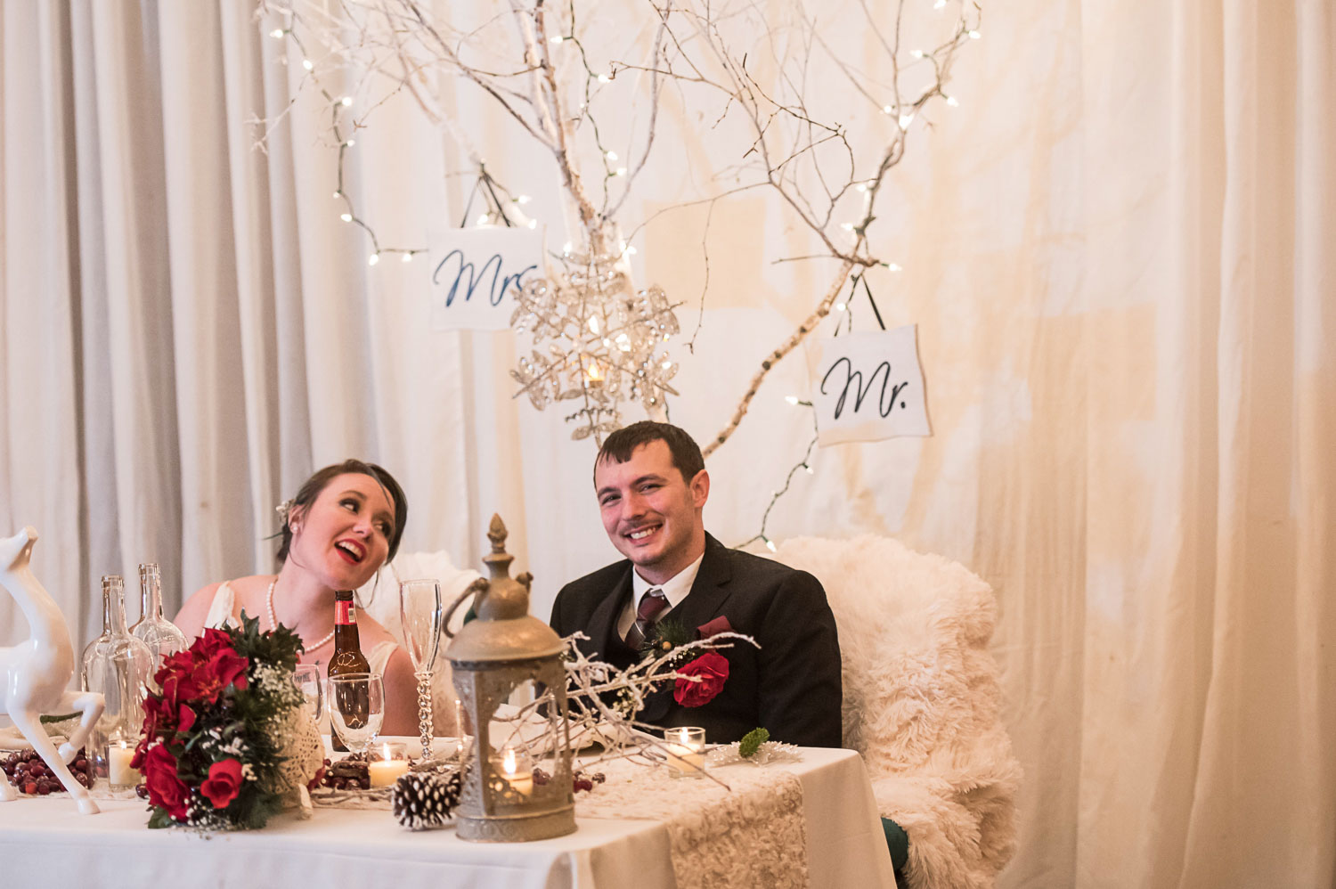 bride and groom sitting at the head table during their Minnesota winter wedding