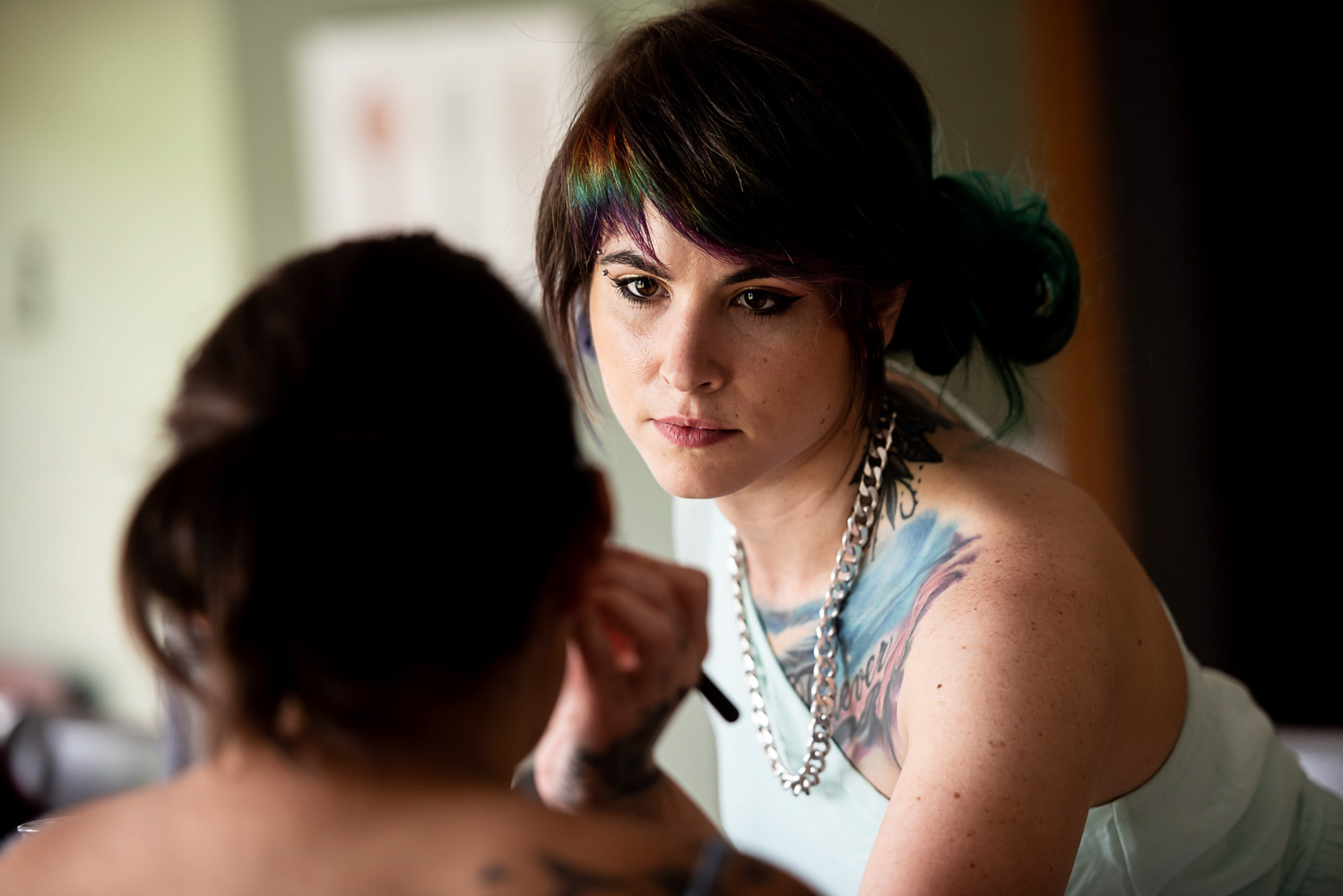 bride getting makeup on for her summer wedding at home in Minnesota