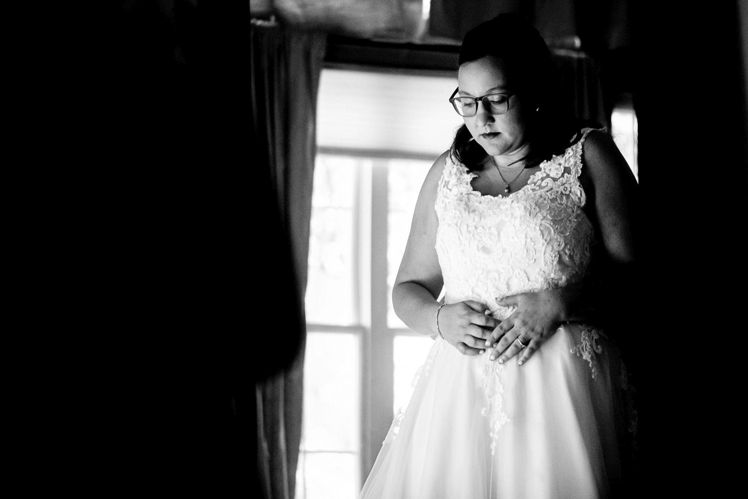 bride getting her wedding dress on at home for her summer wedding