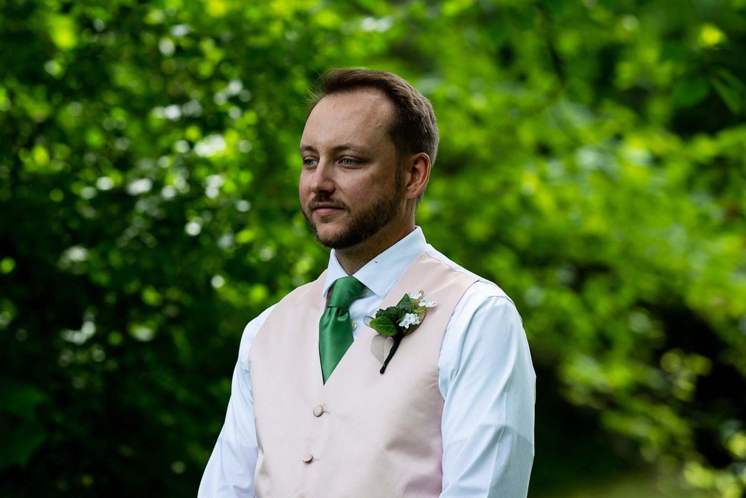 groom waiting for his bride for their first look for their summer wedding at home