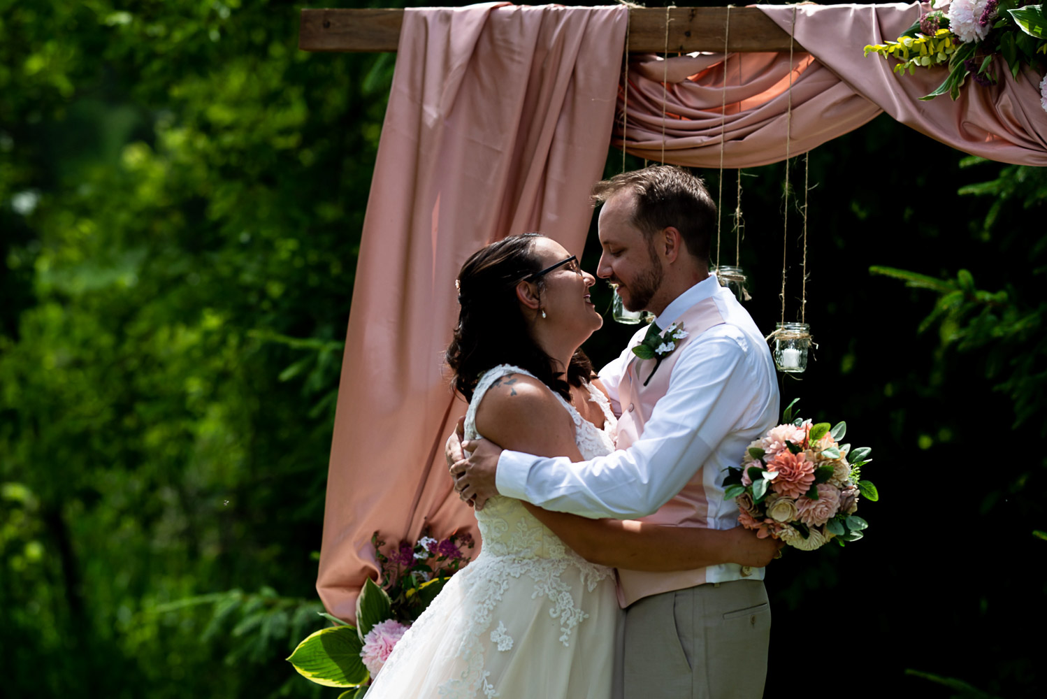 bride and groom kissing at the end of their summer wedding at their Minnesota home