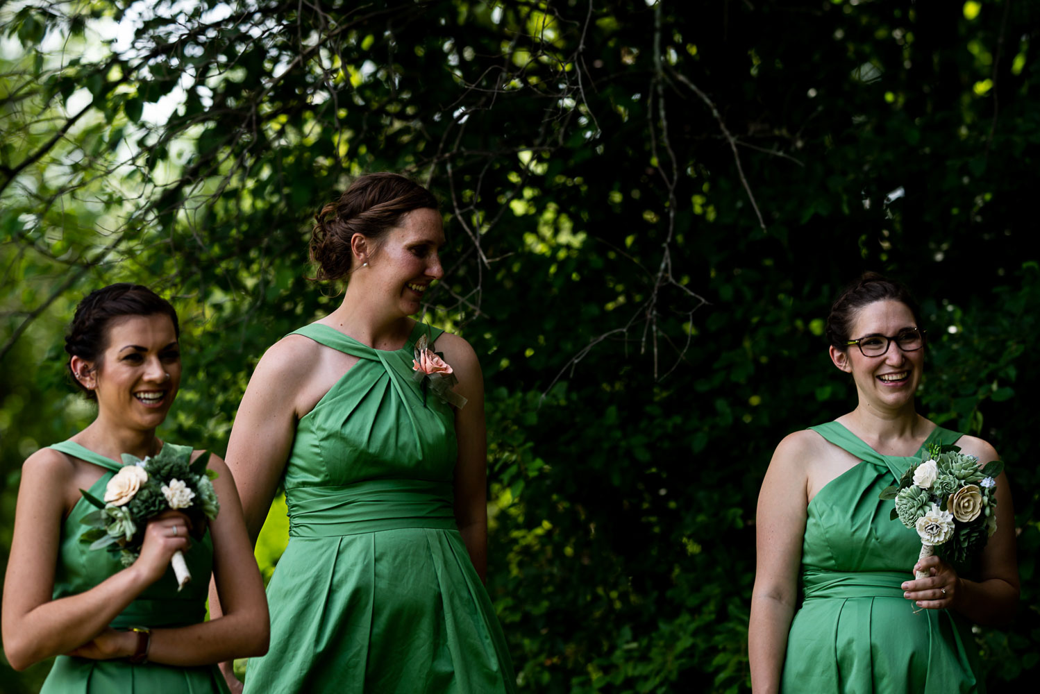 bridesmaid wearing green and laughing 