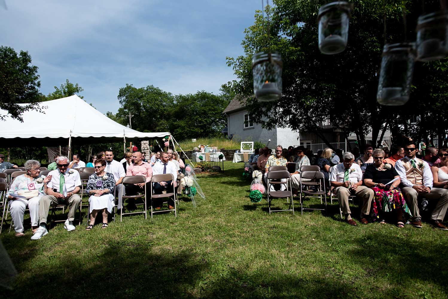 guests sitting on chairs before wedding ceremony 