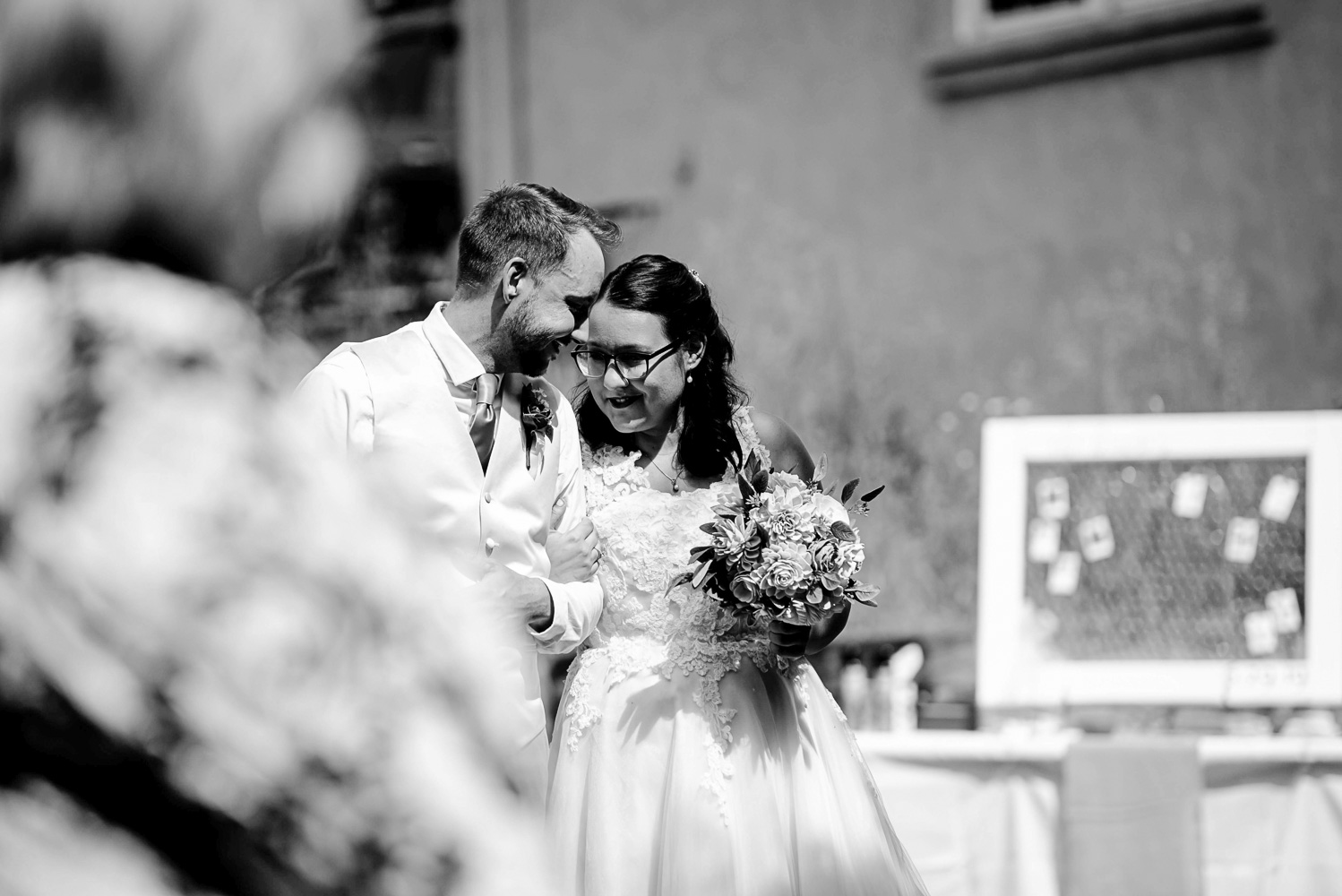 bride and groom touching foreheads before walking down the aisle for their ceremony for their summer wedding 