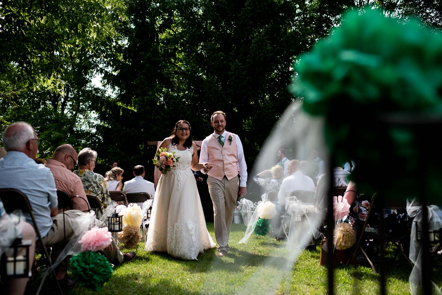 bride and groom walking down the aisle after their summer wedding ceremony 