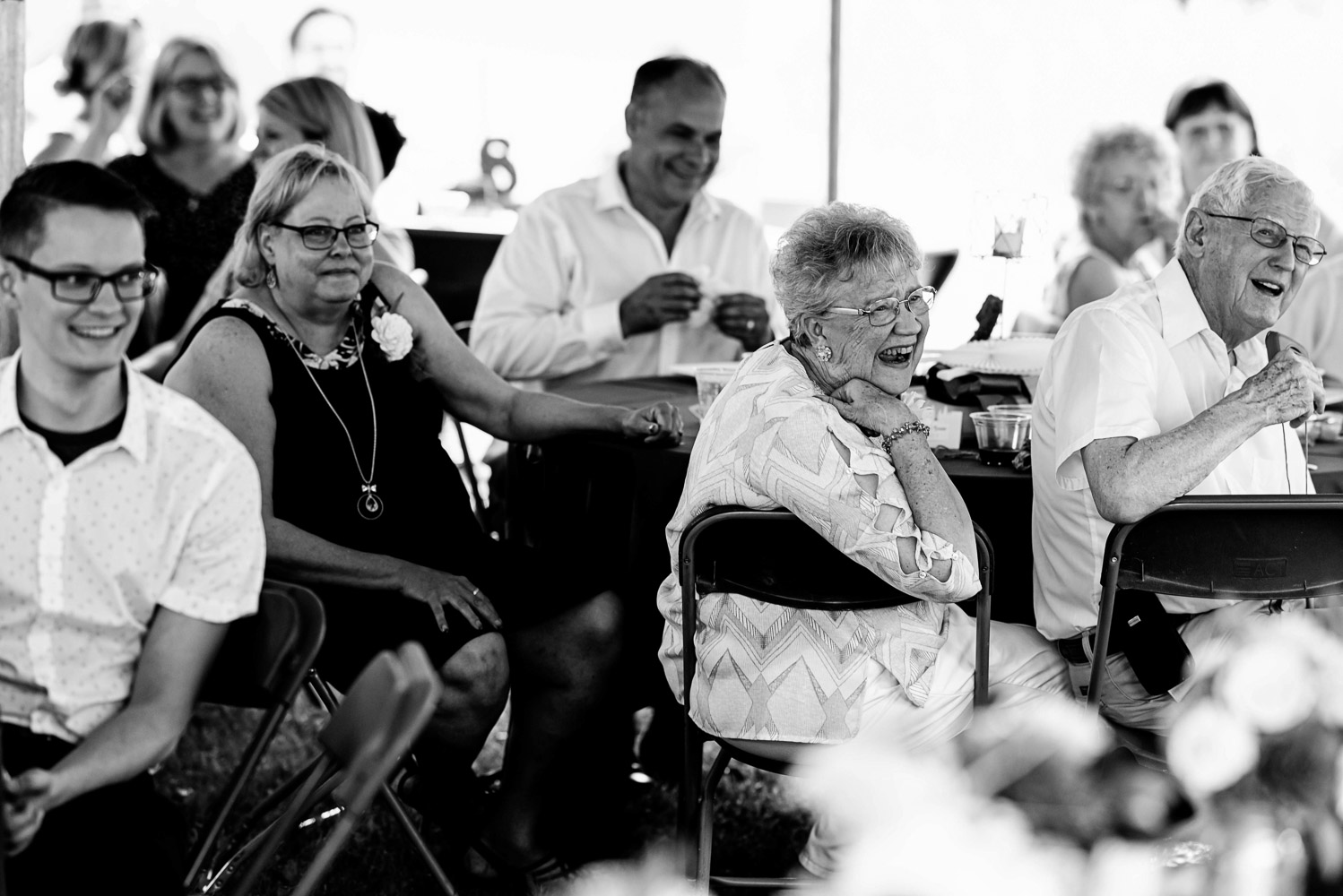 wedding guests laughing during speeches during the reception 