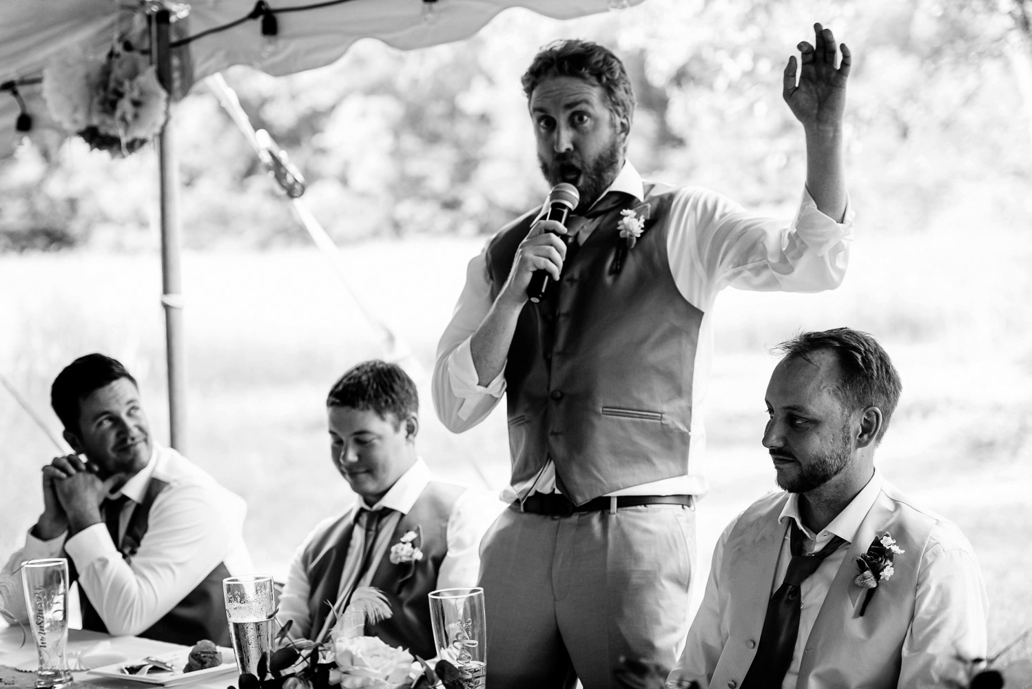 best man giving a speech during the wedding reception at the bride and groom's home for their Minnesota summer wedding