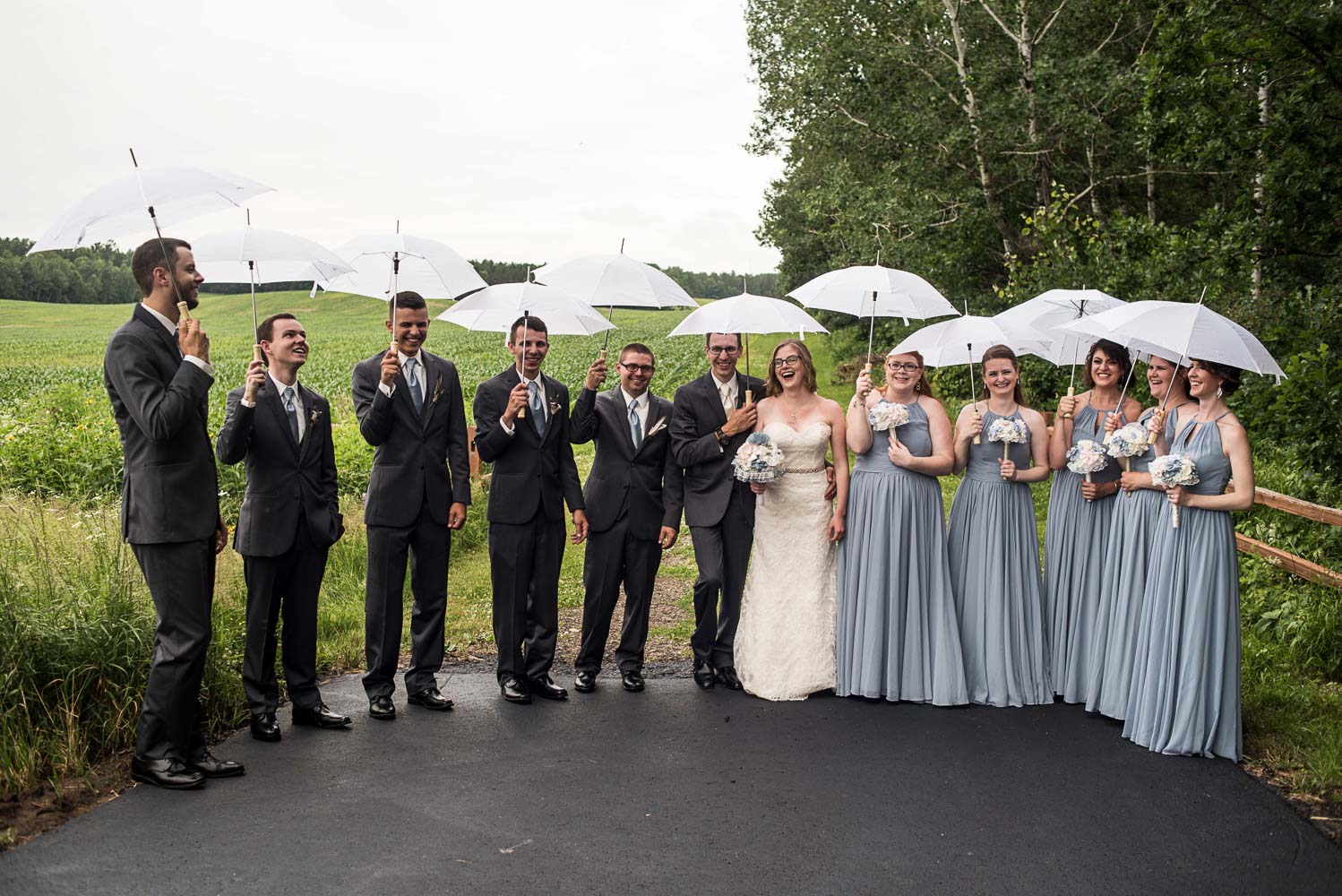 wedding party holding white umbrellas at Pine Peak Lodge