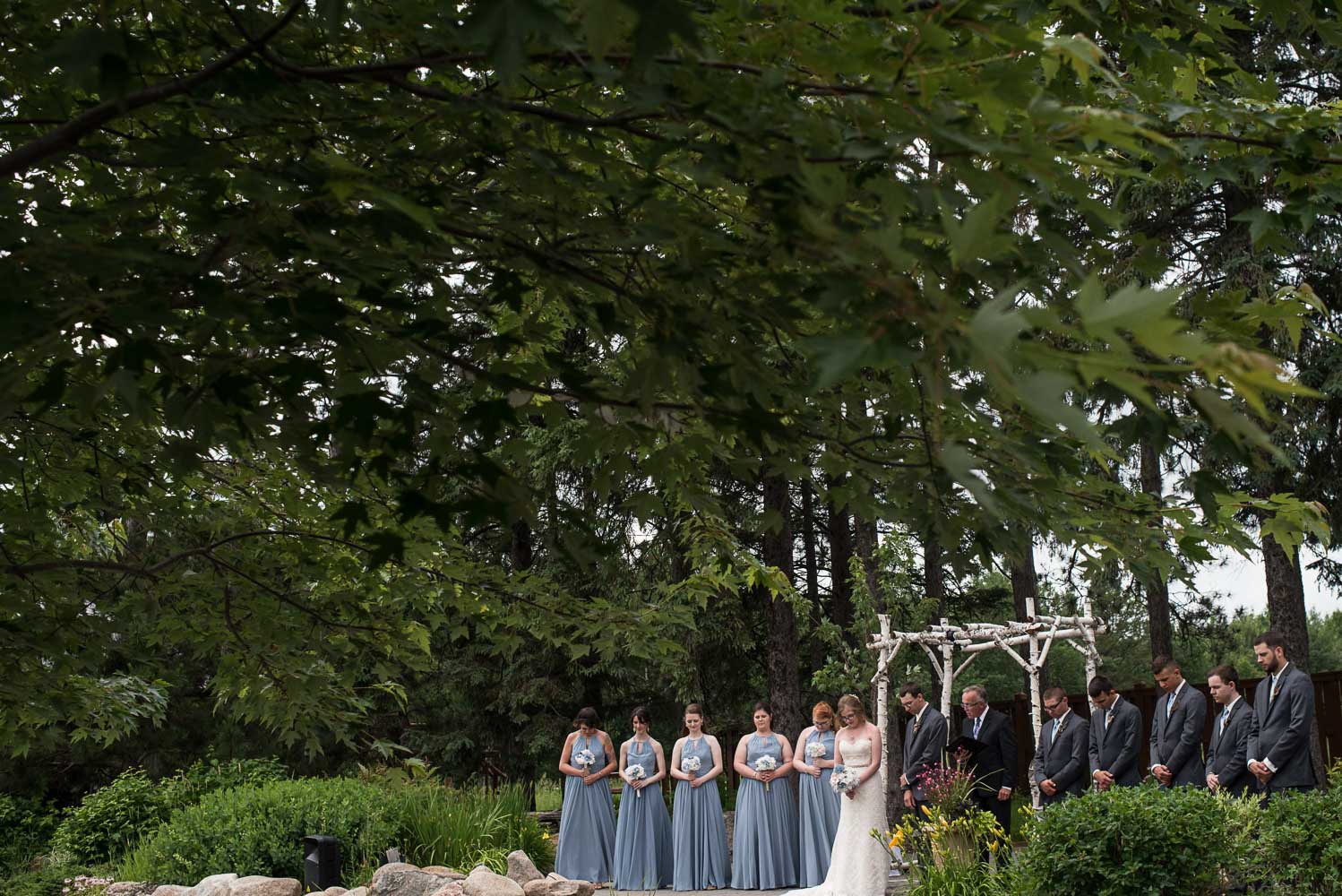 wedding party standing with the bride and groom during the wedding ceremony at Pine Peaks Lodge