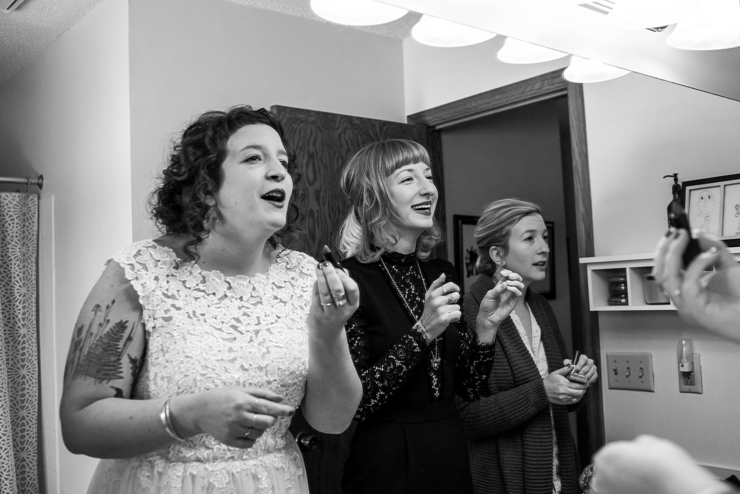 bride and her bridesmaids putting makeup on before the wedding at Turtle's 1890 Social Centre