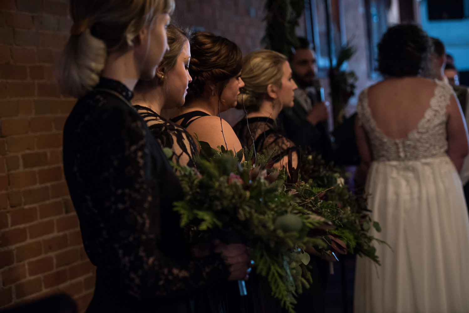 bridesmaids standing at the alter watching the bride and groom during the ceremony at Turtle's in Minnesota