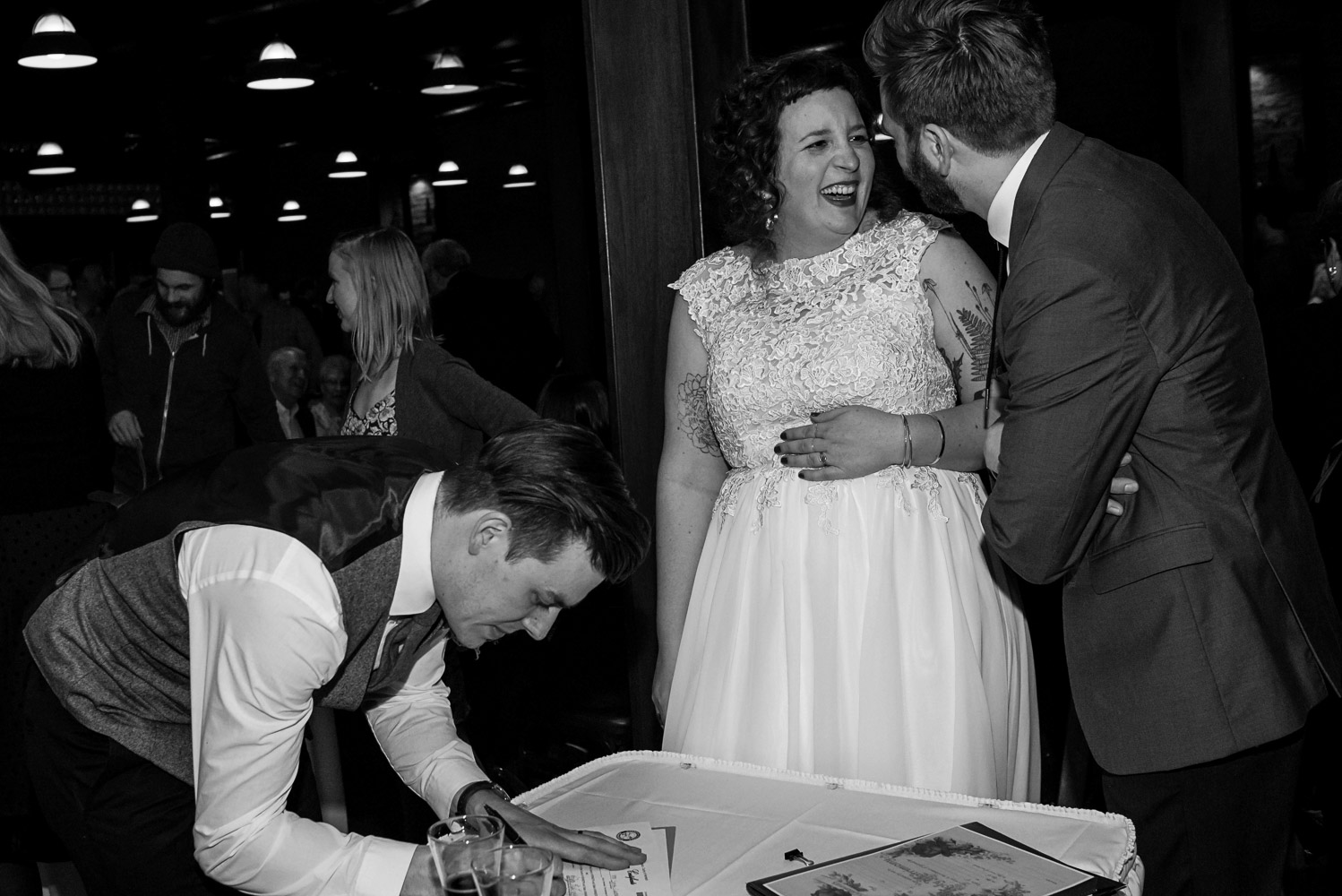 bride and groom signing their marriage license after the wedding ceremony at Turtle's 