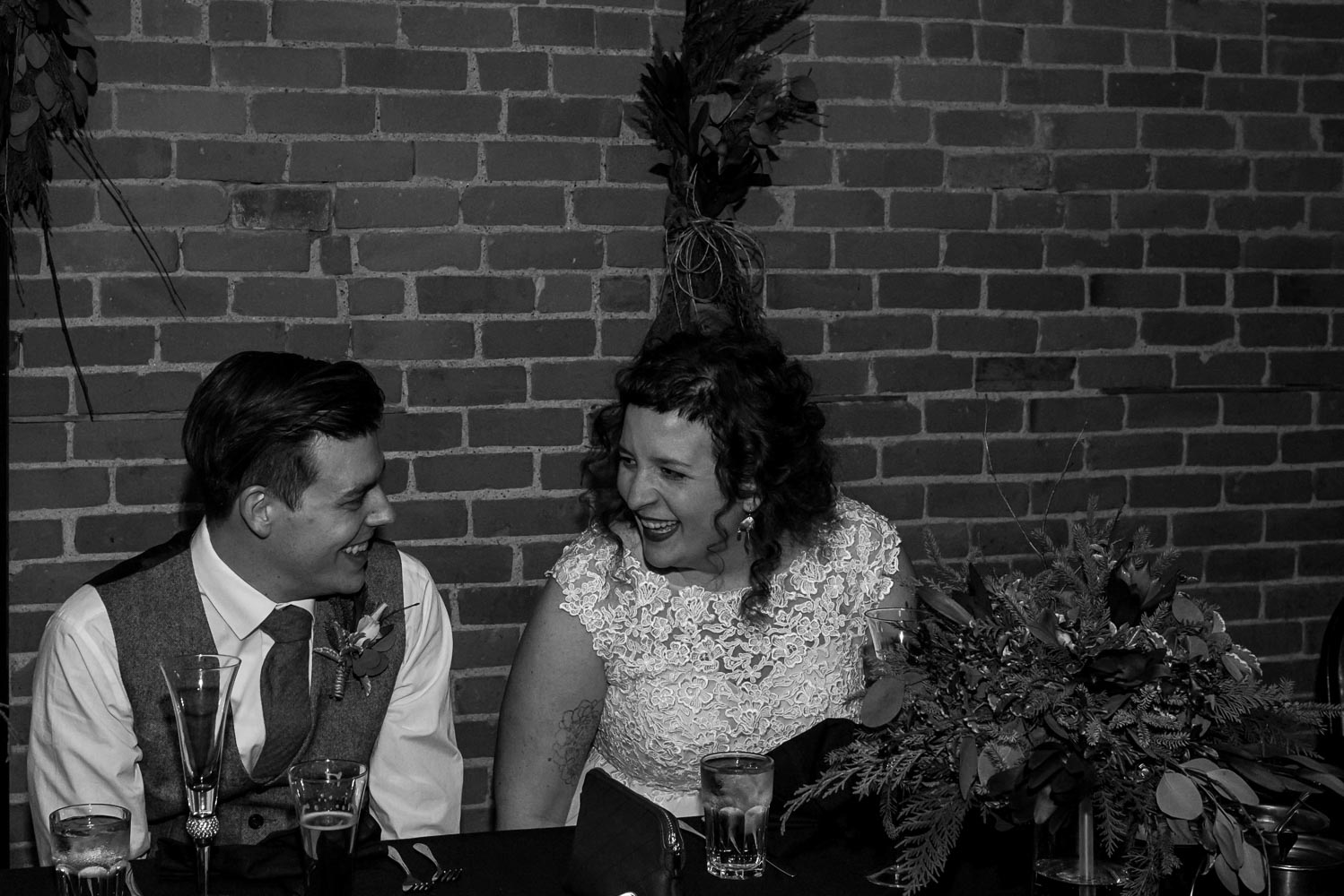 bride and groom laughing during dinner at Turtle's 1890 Social Centre