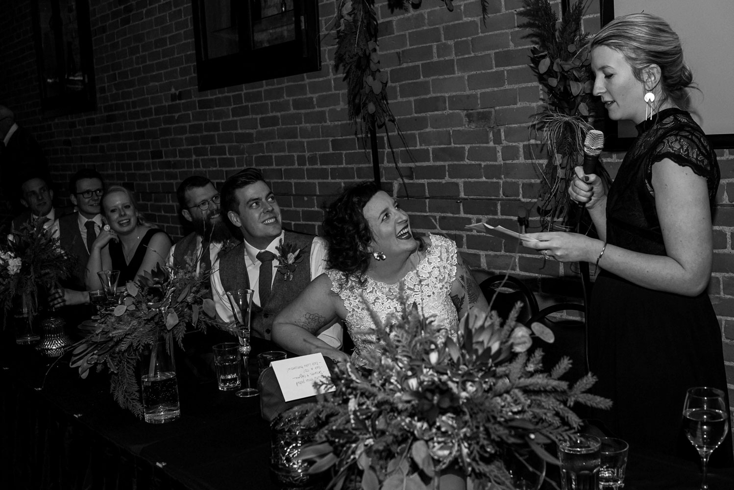 bride and groom laughing during the maid of honor's speech at Turtle's in Minnesota
