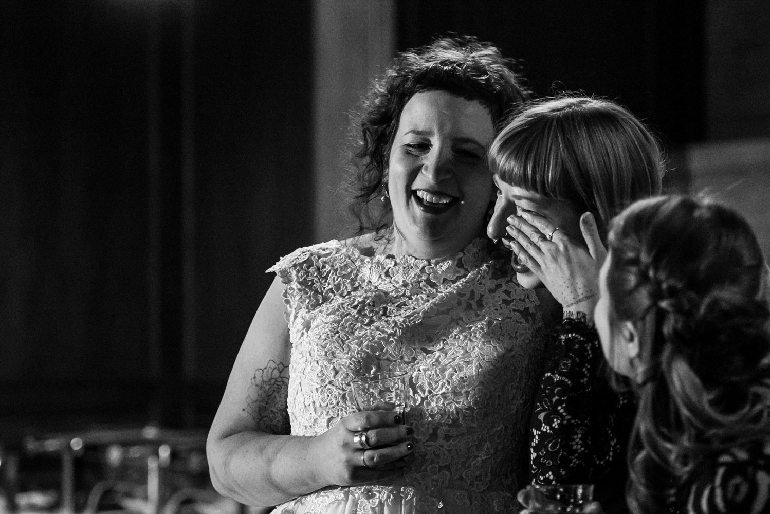 bridesmaid crying and hugging the bride