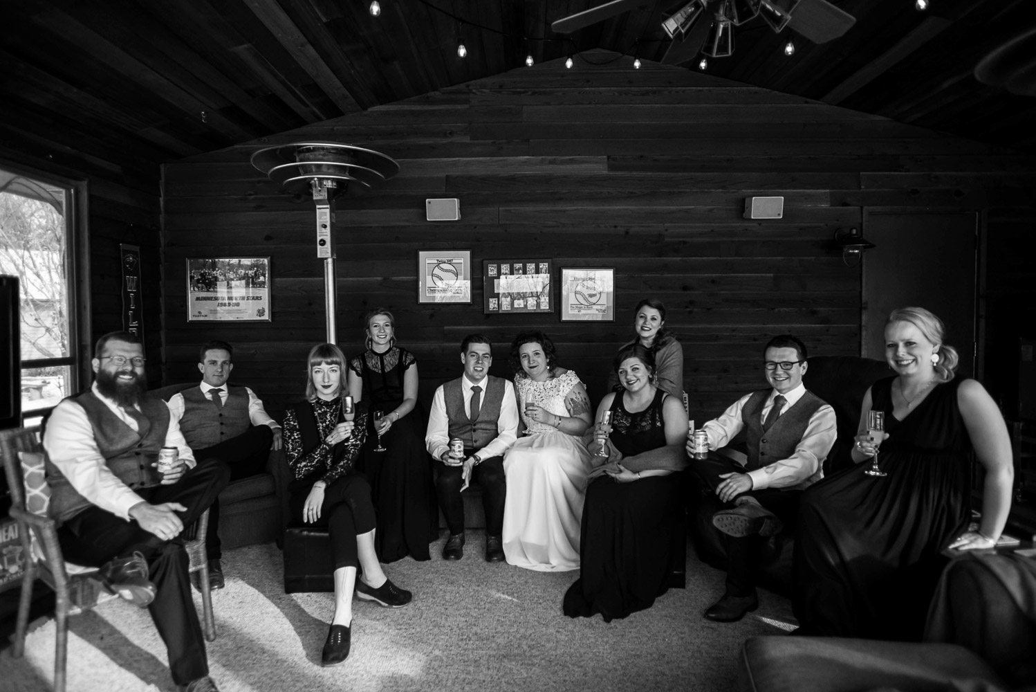 bride and groom with their wedding party sitting in their 4 season porch