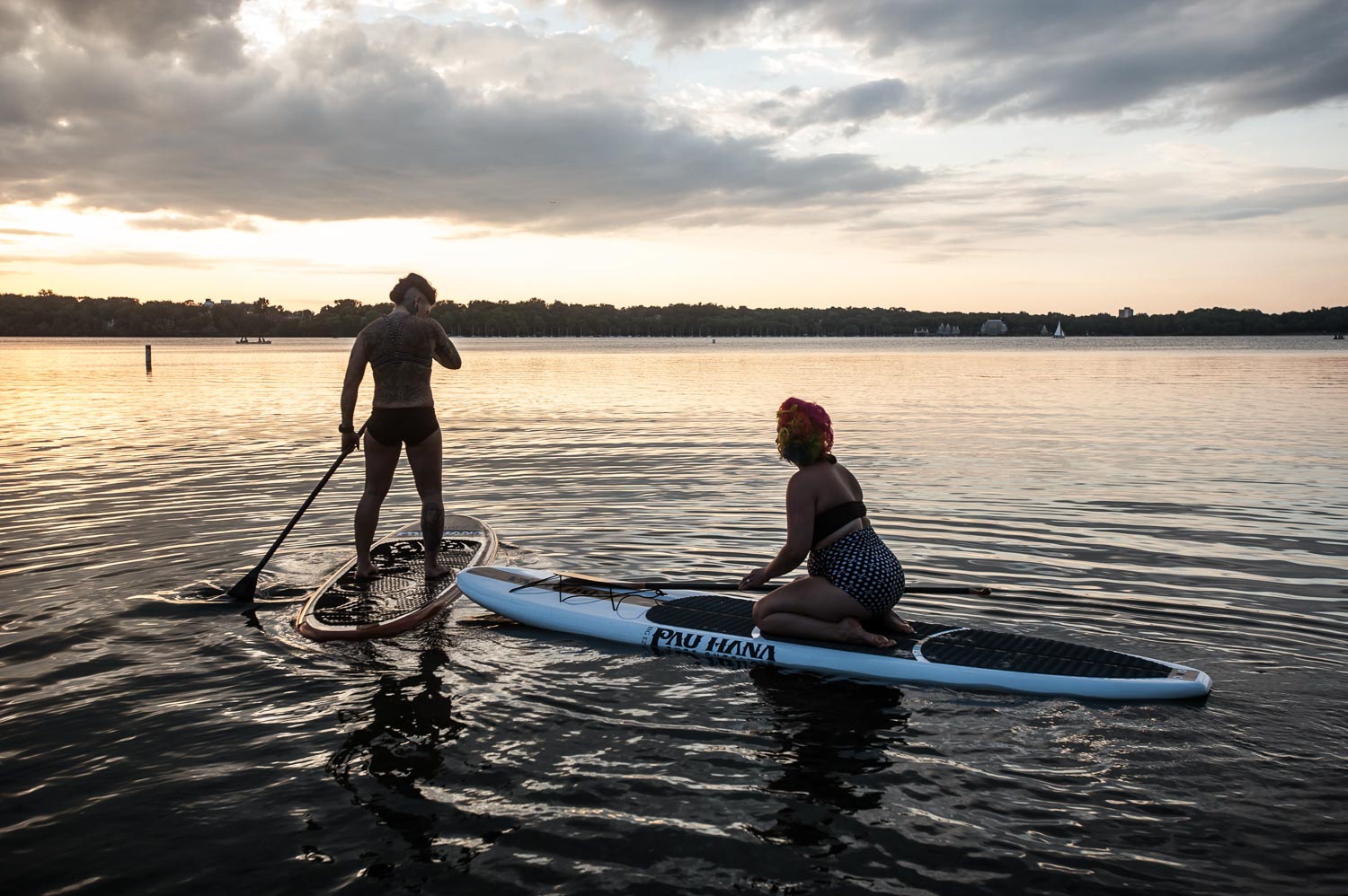 LGBTQ couple paddleboarding on Lake Harriet