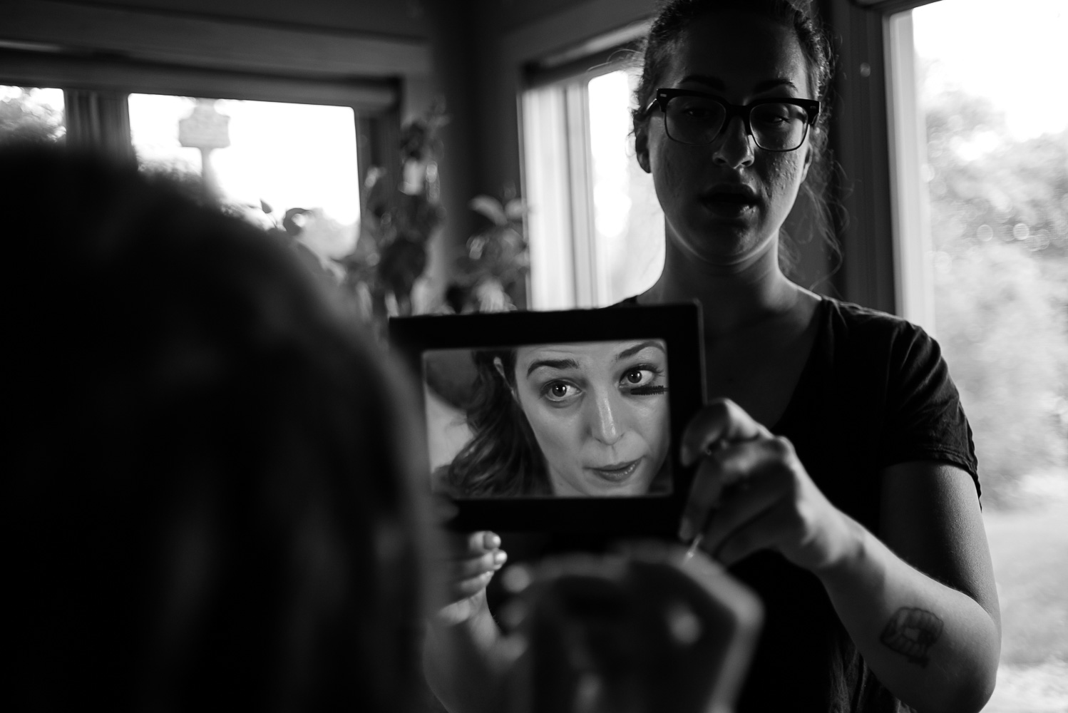 bride looking at herself in the mirror as she gets ready for her wedding day