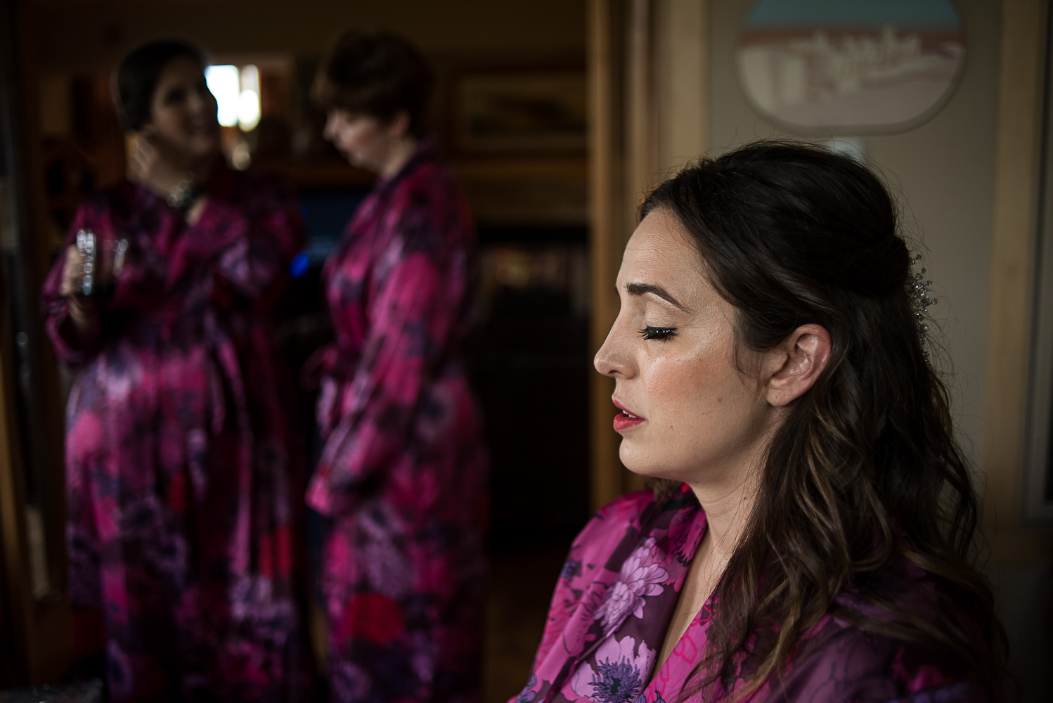bride wearing a pink robe getting ready for her wedding at her parents home in Victoria