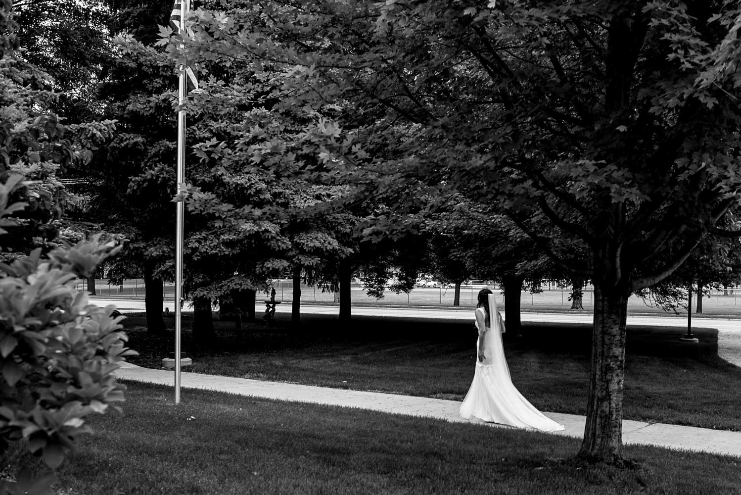 bride walking next to the church to her wedding ceremony at St. Victoria Catholic Church