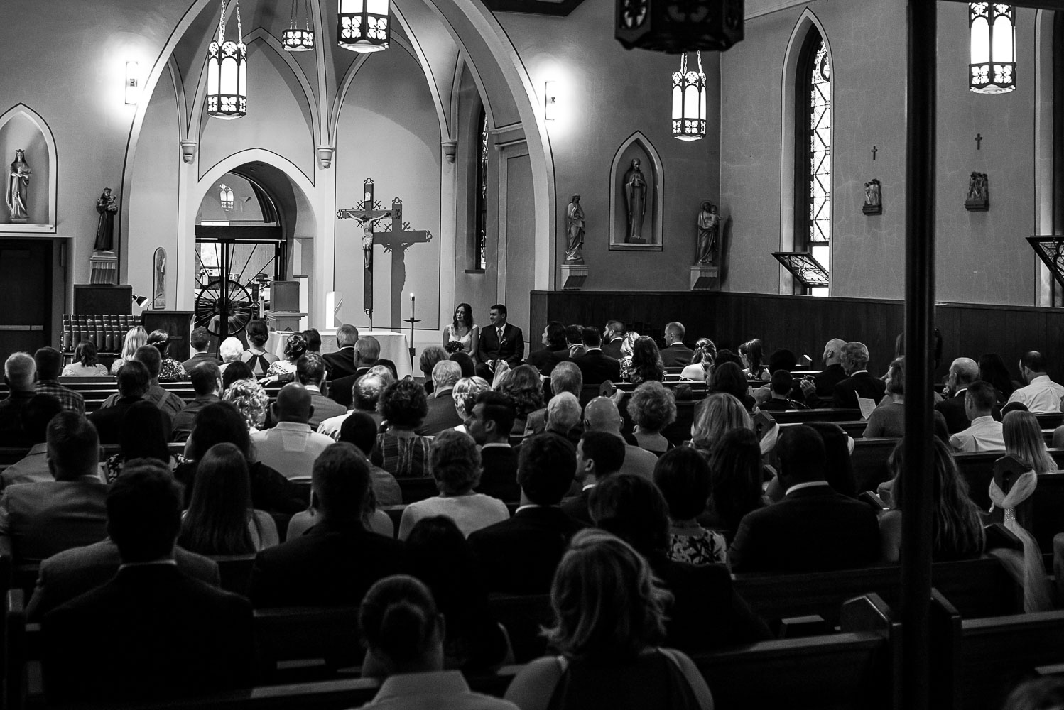 wedding guests and wedding party during the ceremony at St. Victoria Catholic Church in Minnesota