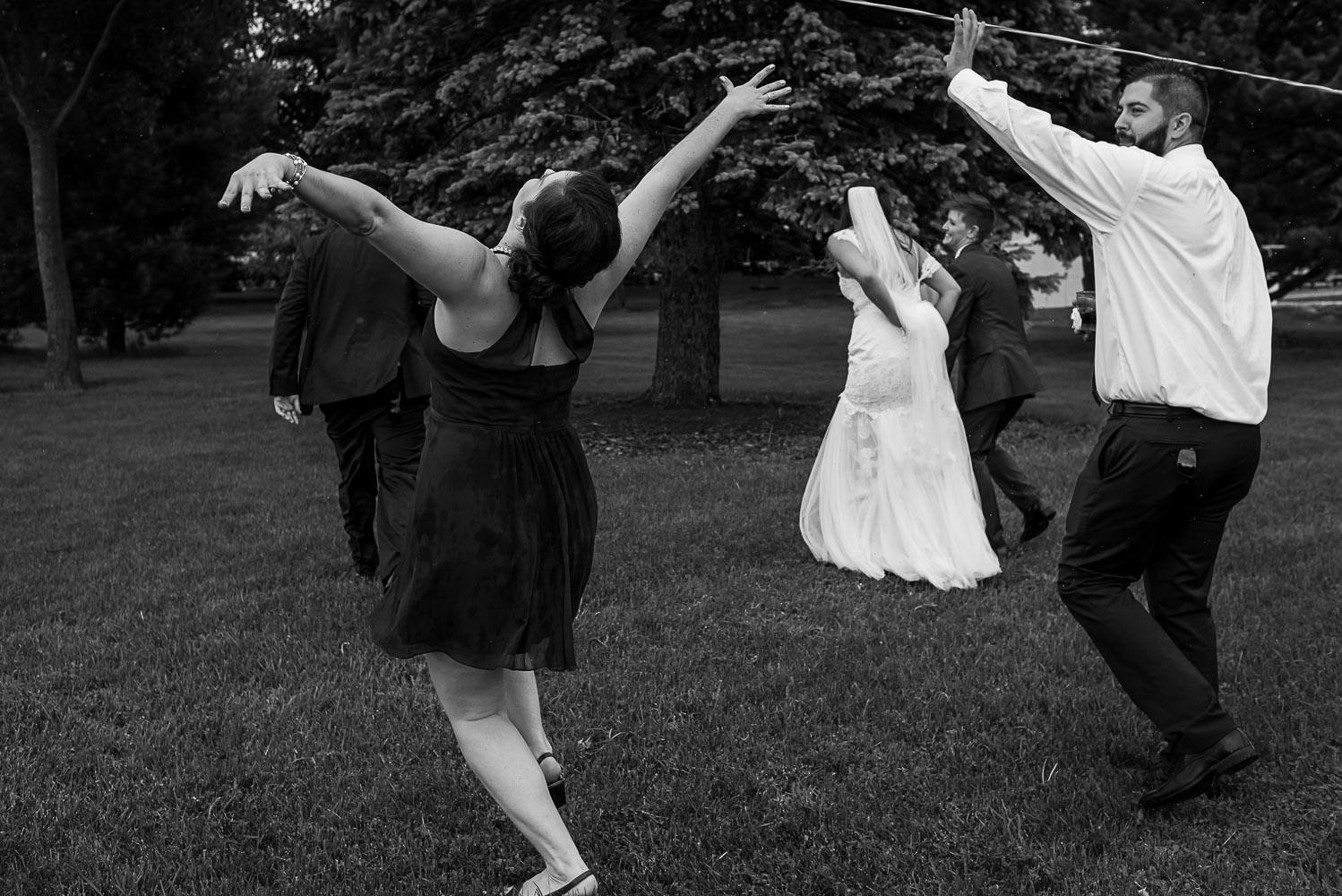 bride and bridesmaid playing in the rain at the Winery at Sovereign Estate