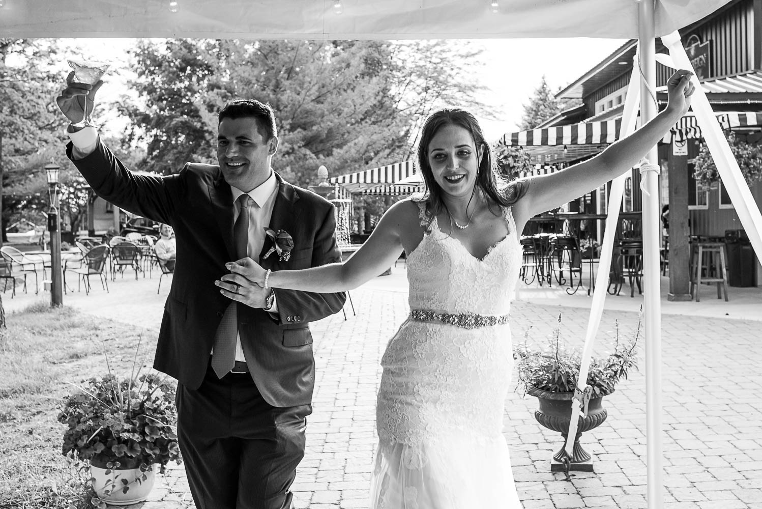 bride and groom walking into their reception at