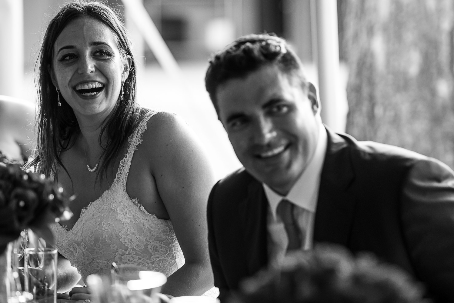 bride and groom laughing while sitting at dinner at their wedding reception at the Winery at Sovereign Estate