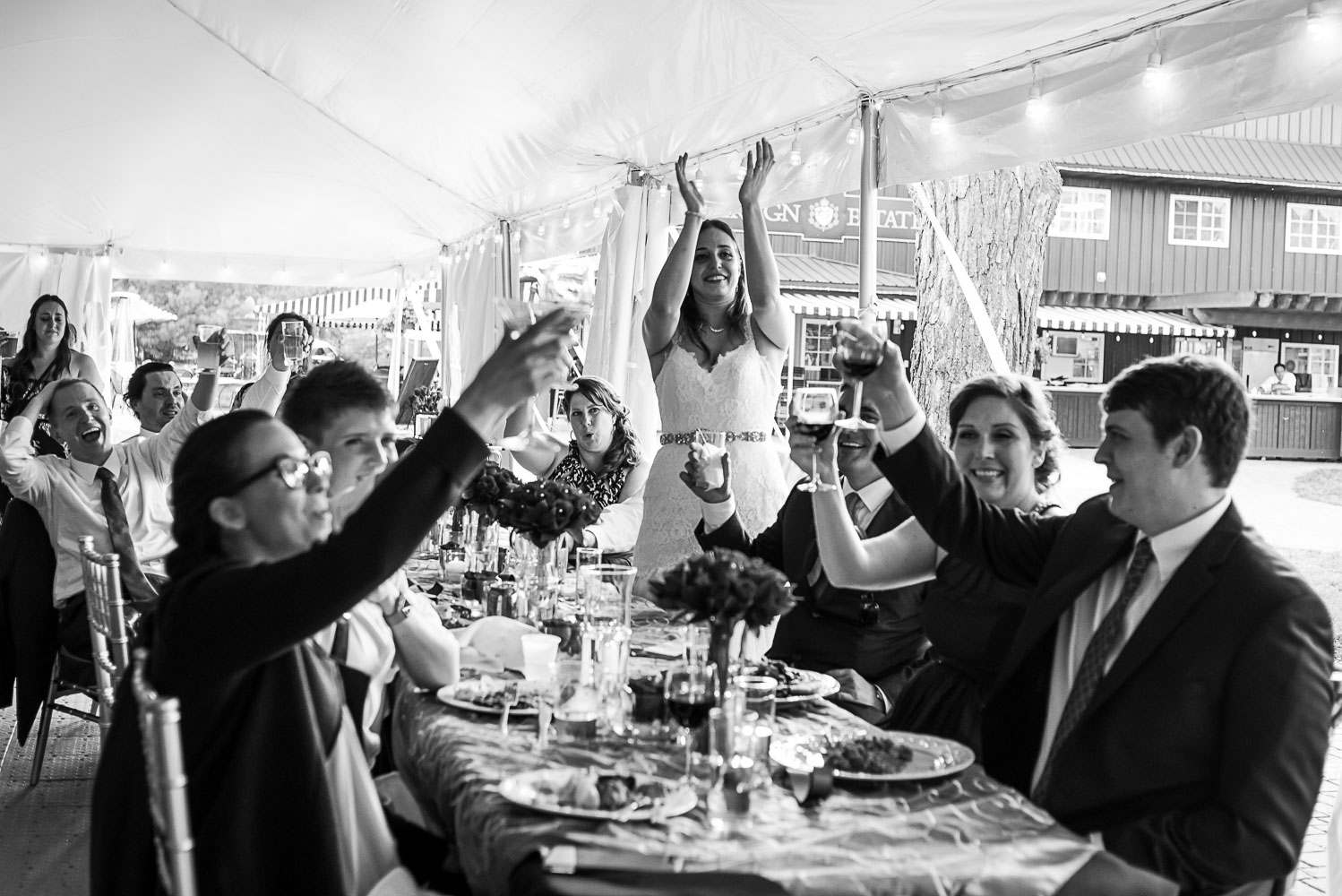bride and groom laughing while sitting at dinner at their wedding reception at the Winery at Sovereign Estate