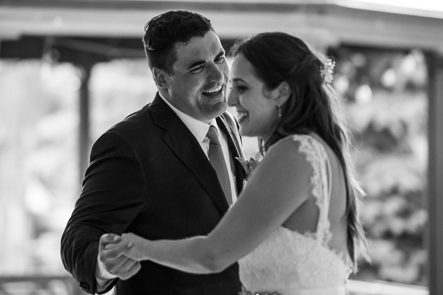 bride and groom having their first dance at their reception at bride and groom laughing while sitting at dinner at their wedding reception at the Winery at Sovereign Estate