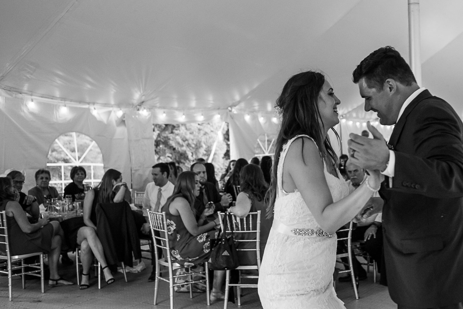 first dance between the bride and groom during their reception at bride and groom laughing while sitting at dinner at their wedding reception at the Winery at Sovereign Estate