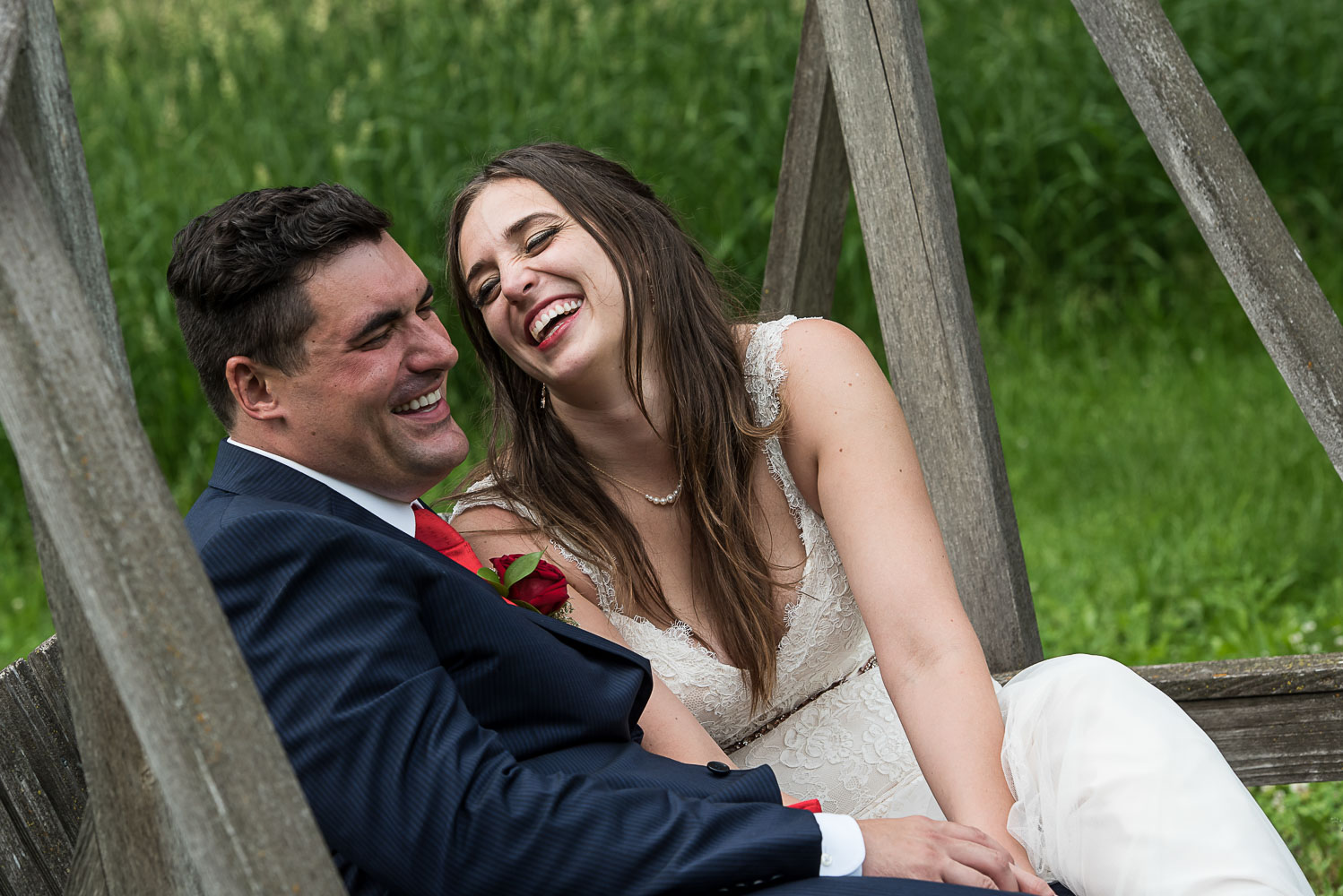 bride and groom rocking on a swing laughing and holding hands in the vineyard at bride and groom laughing while sitting at dinner at their wedding reception at the Winery at Sovereign Estate