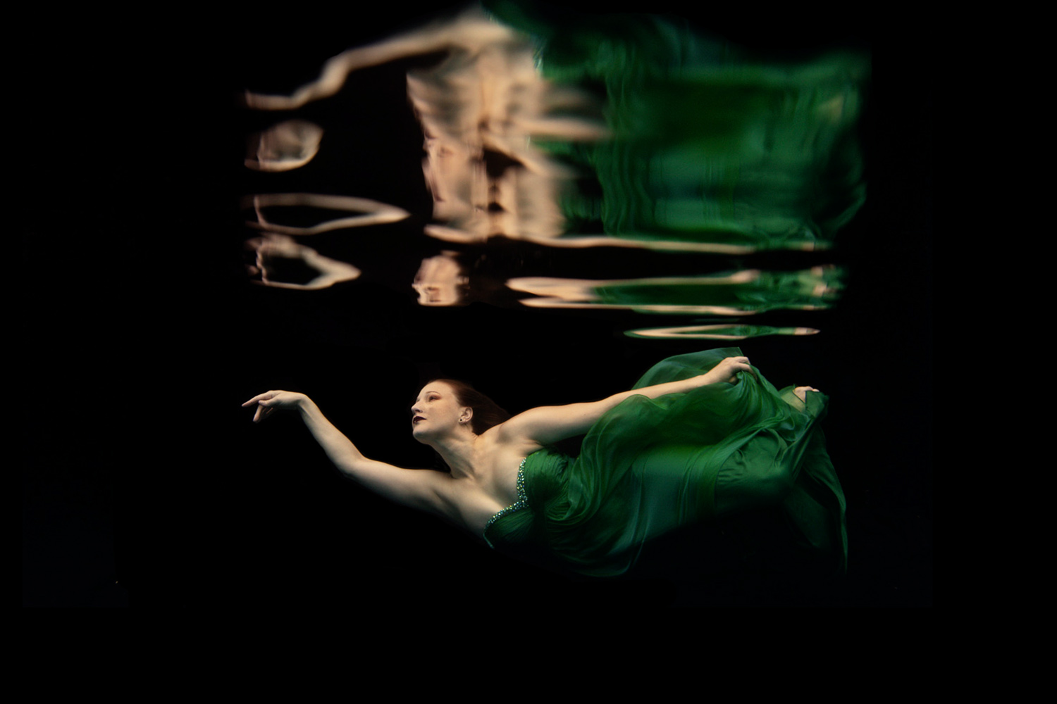 woman in a green dress underwater