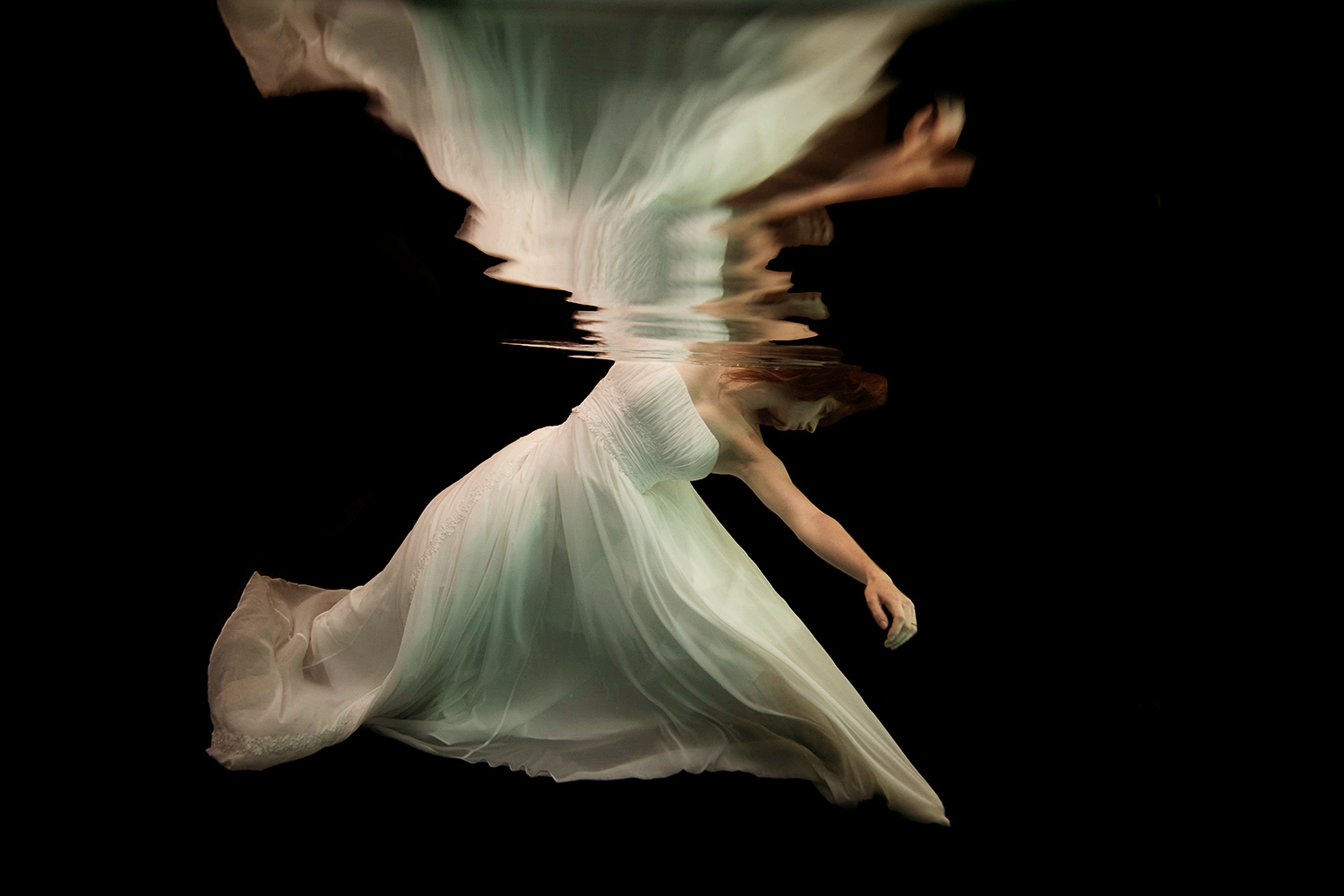 woman in a wedding dress underwater