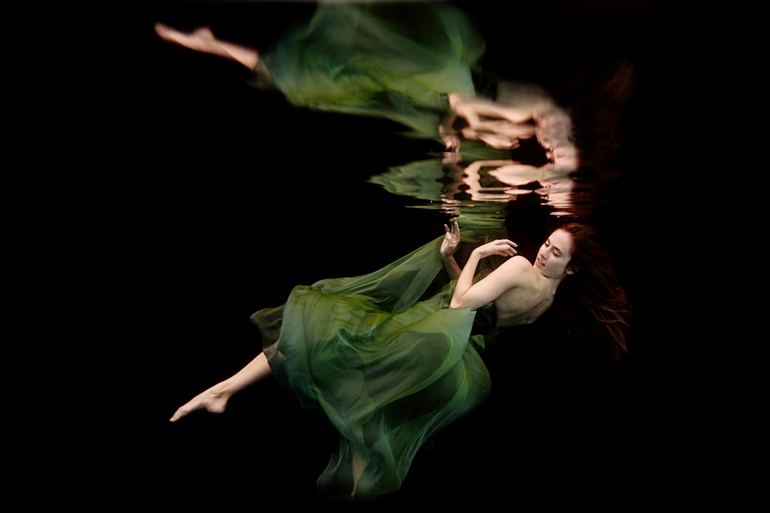 underwater fashion shoot with a woman in a green dress