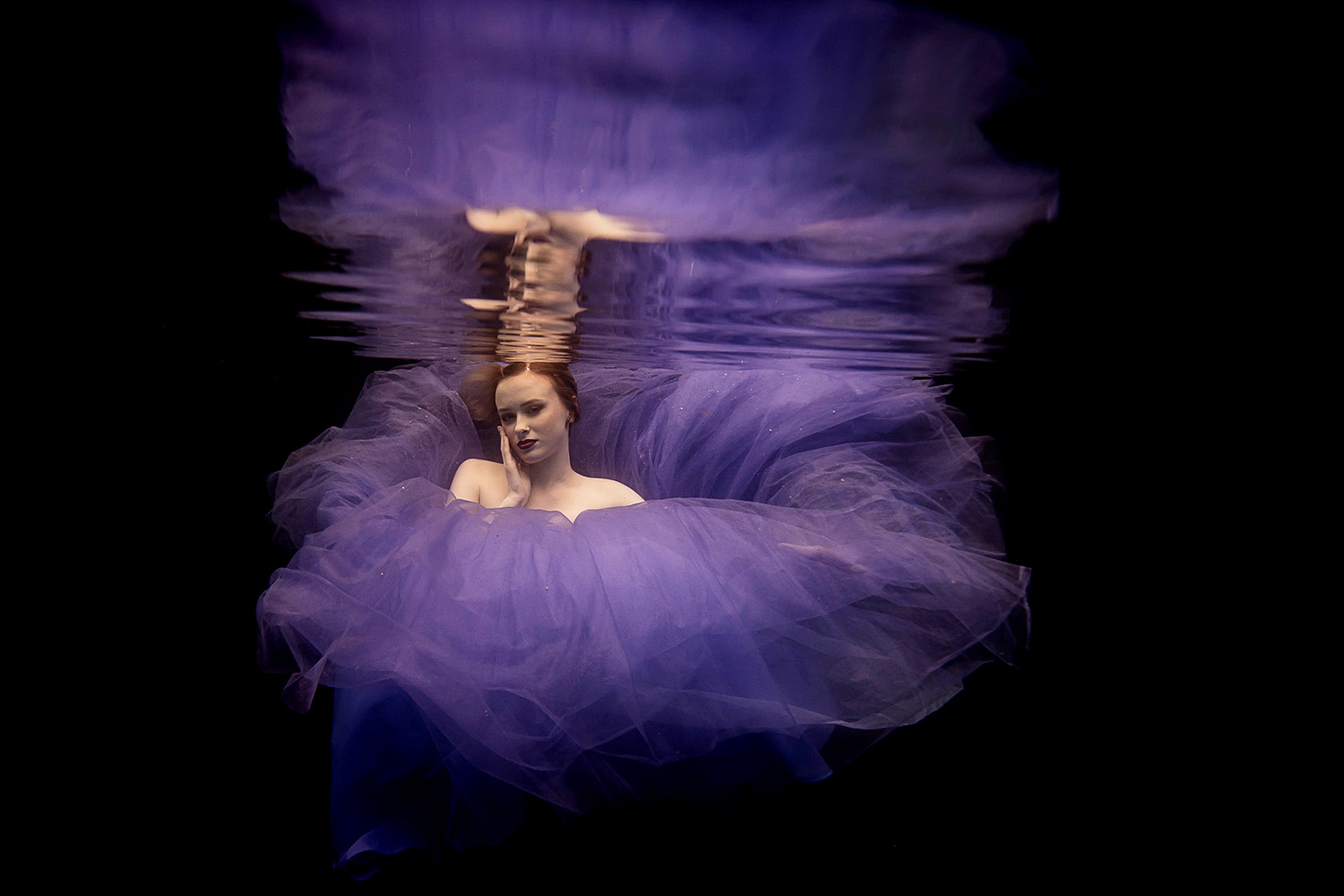 girl in a purple prom dress during an underwater fashion shoot