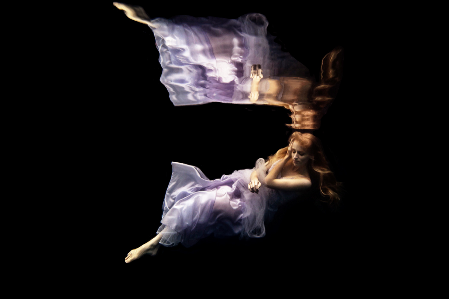 girl in a purple dress for an underwater fashion shoot in Minnesota