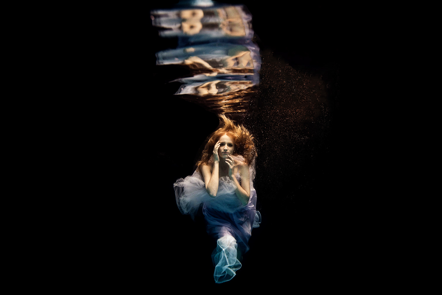 girl wearing a blue and purple dress underwater
