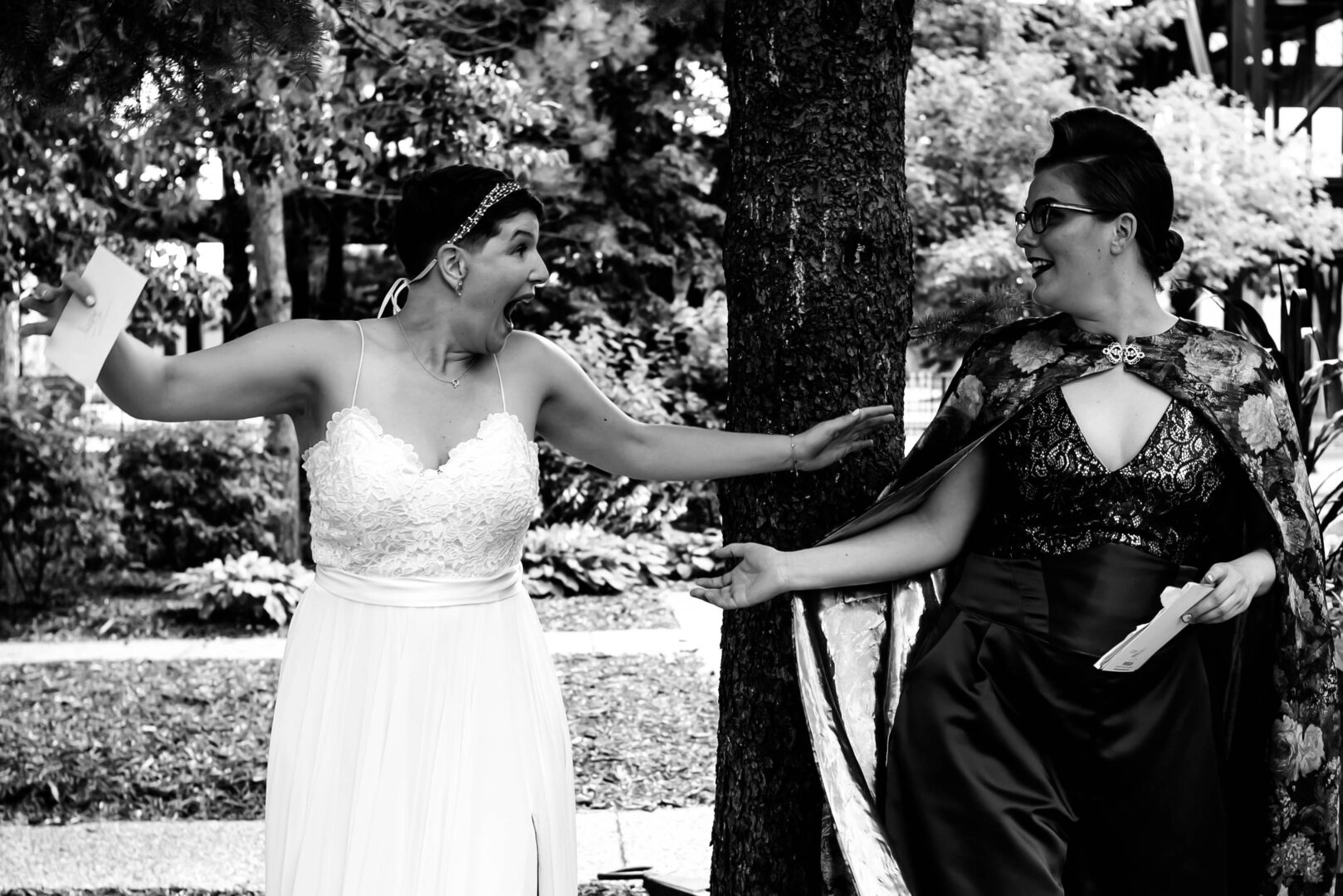 Brides hold arms out prior to embracing during first look prior to wedding ceremony.