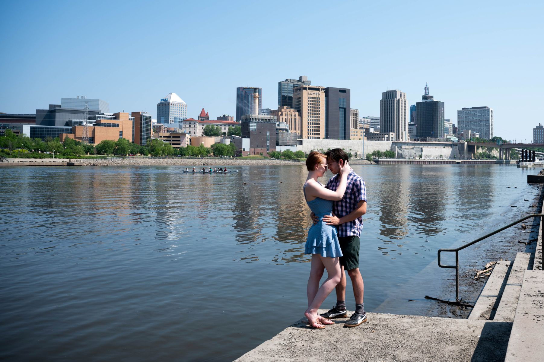 a couple taking engagement photos at harriet island in st paul